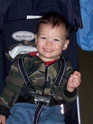 Tad smiles from his stroller
