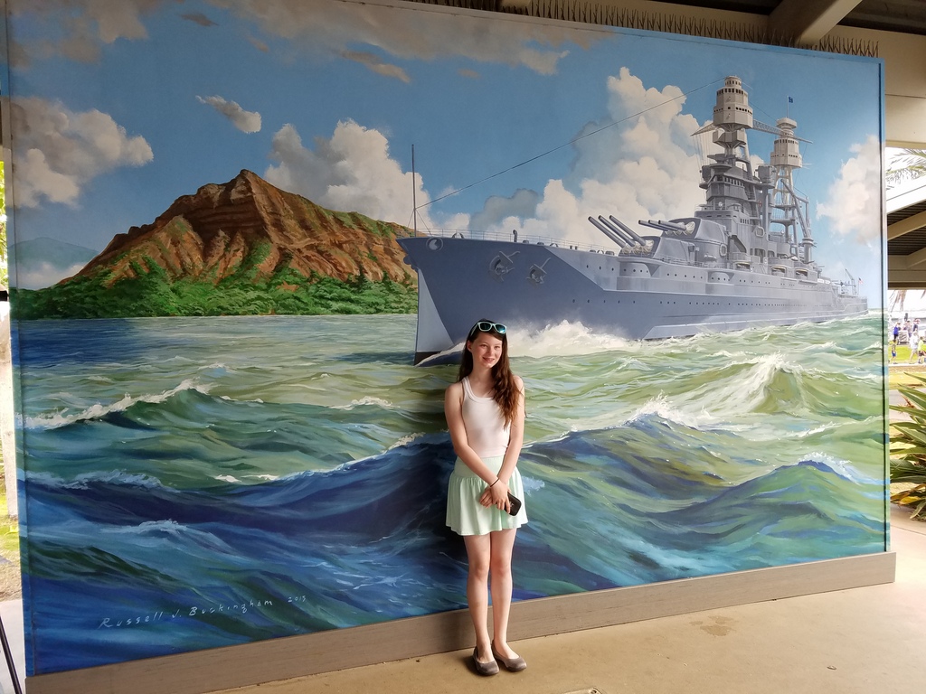 Ane next to a mural
